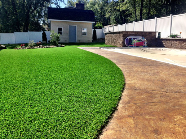 Landscape Grass Transition from Stamped Concrete Pool Deck